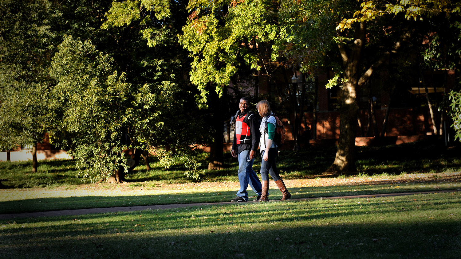 NCSU students walk across the Court of Carolinas on a sunny fall afternoon.