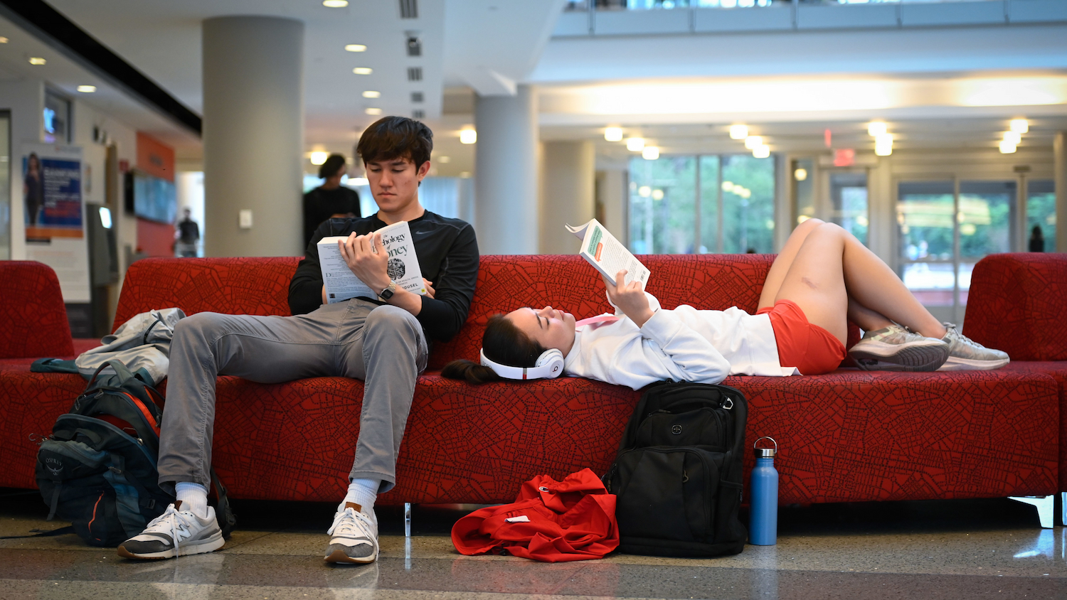 Undergraduate students chill out on a warm afternoon while reading a book at the Talley Student Union on main campus.